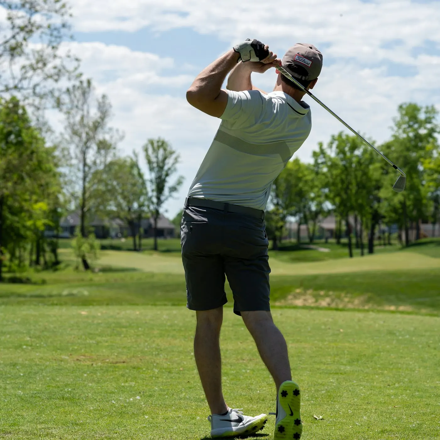 Golfer finishing a smooth swing on a green fairway